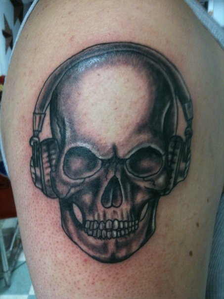 Skull with headphones tattoo